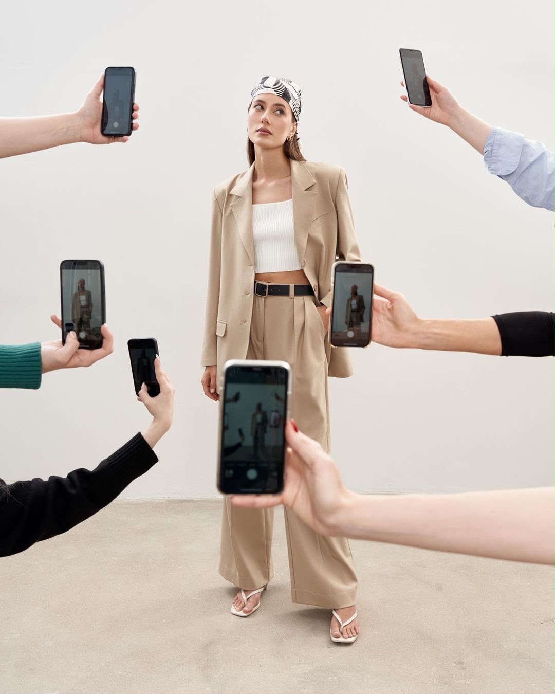 Creators photographing a model with phones